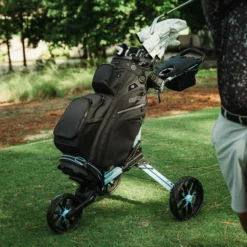 Image of BagBoy Nitron Auto Open Push Cart Ice Blue and White on Golf Course with Bag