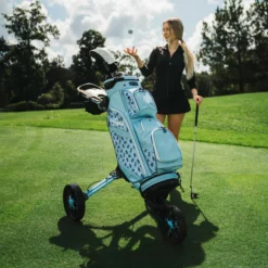 Image of BagBoy Nitron Auto Open Push Cart Ice Blue and White on Golf Course