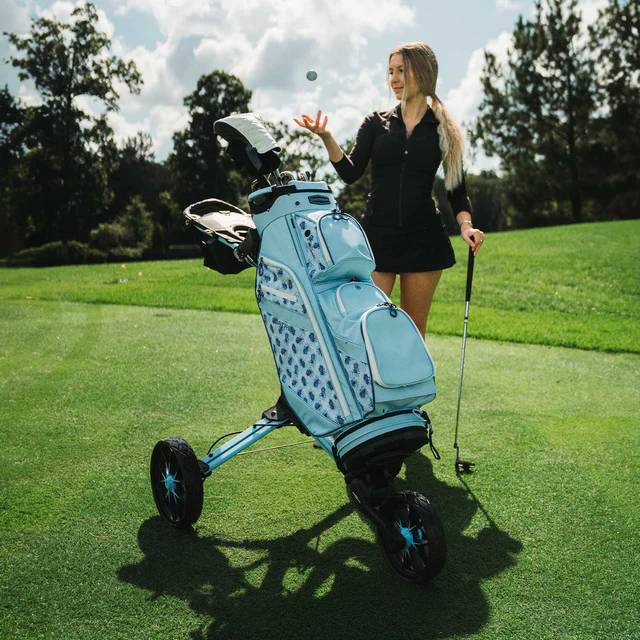 Image of BagBoy Nitron Auto Open Push Cart Ice Blue and White on Golf Course